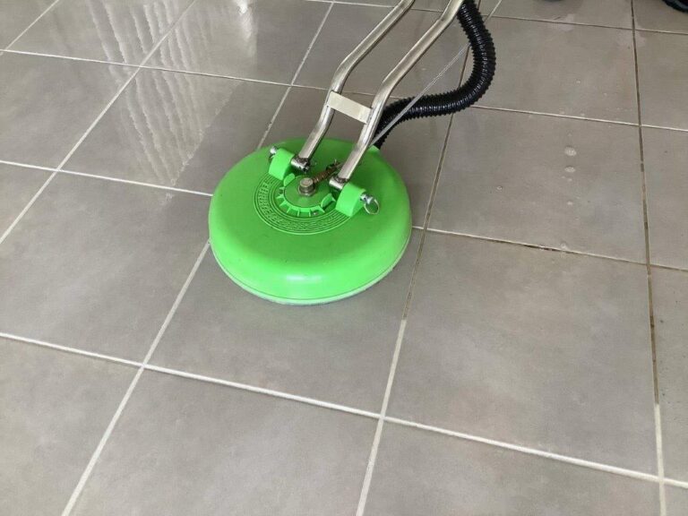 Dirty tiles being cleaned by a cleaning machine