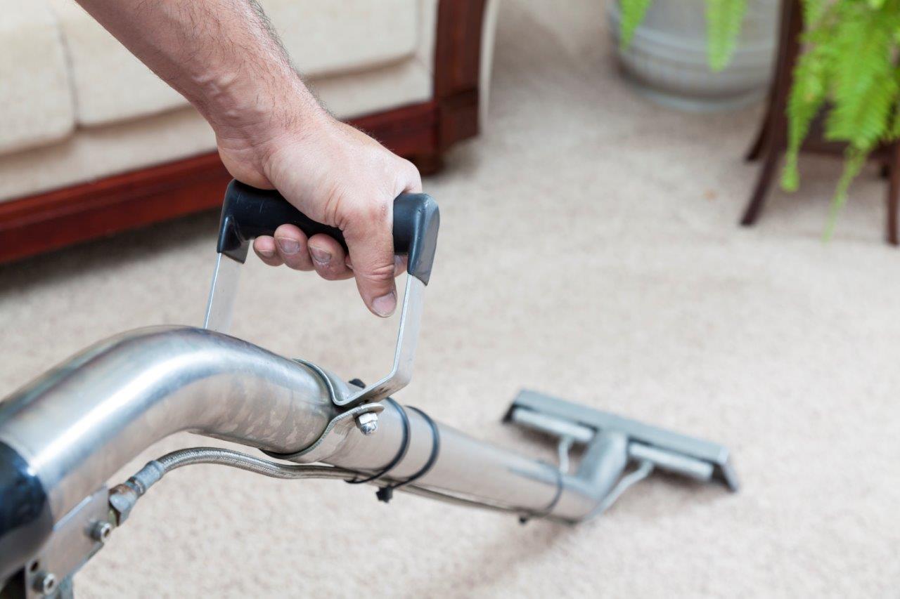 Man using carpet cleaning wand